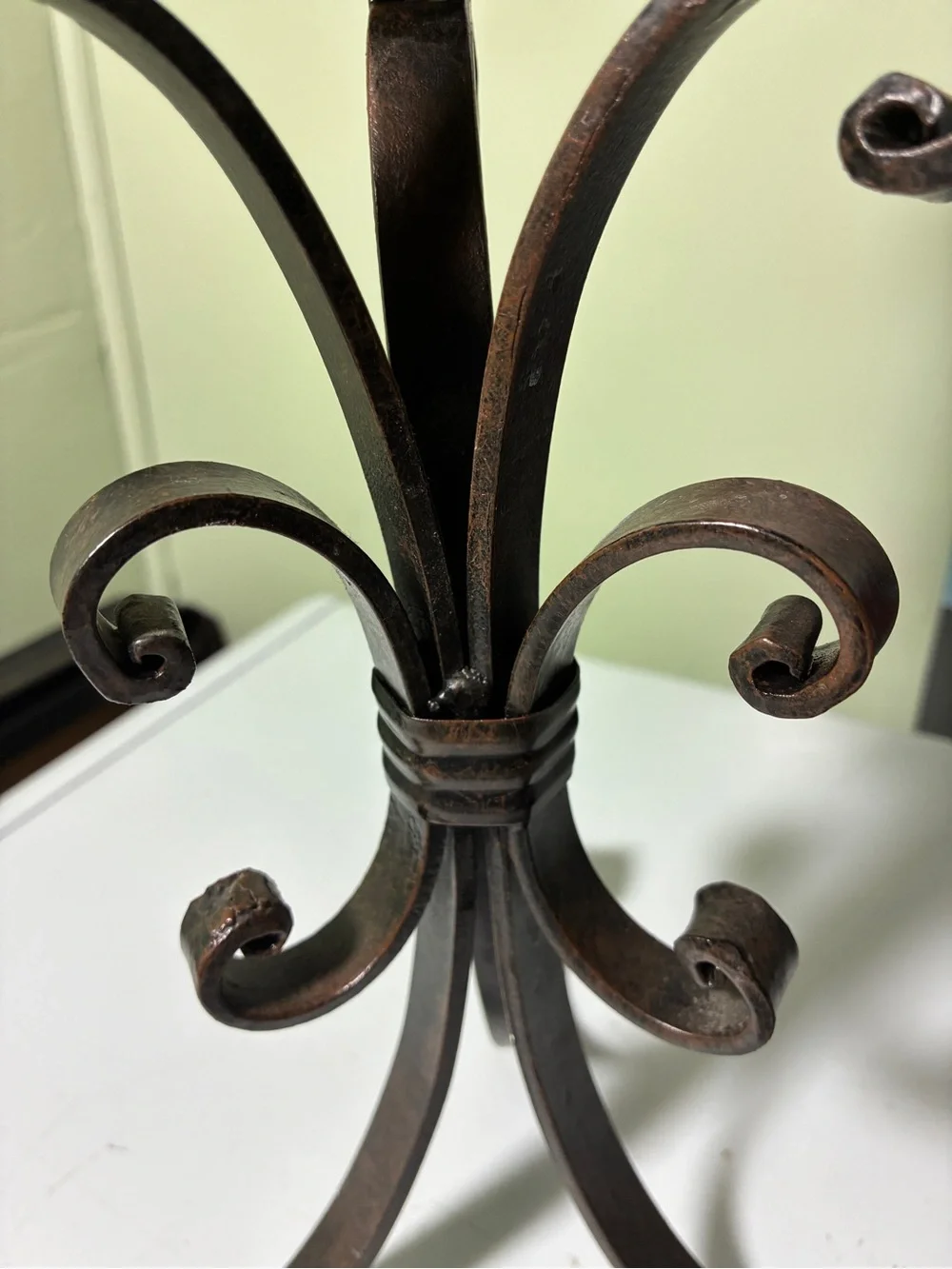 vintage wrought iron candle holder features a dark metal scroll and ring design